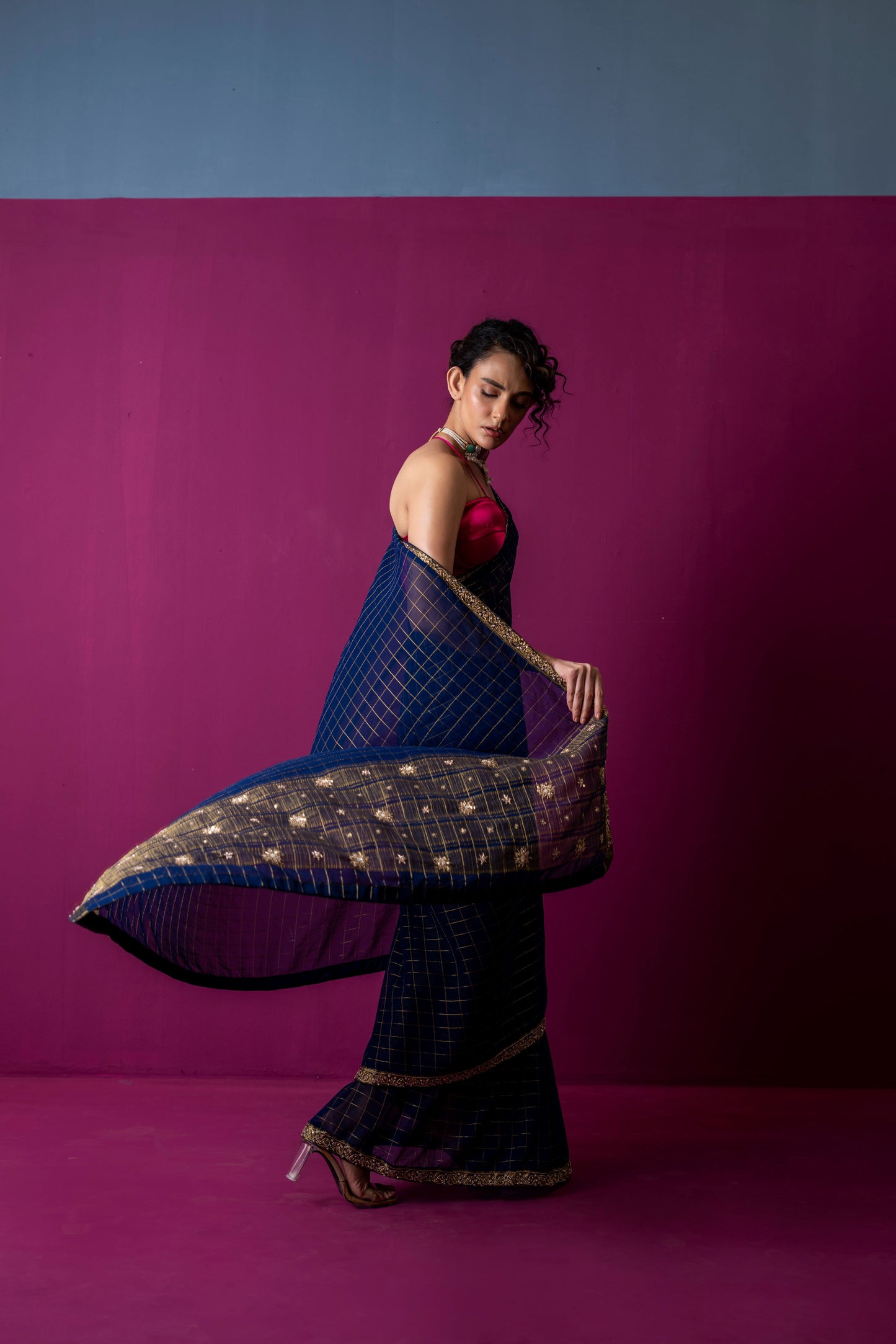 A Navy Gold Checkered Saree with Fuchsia Corset Blouse