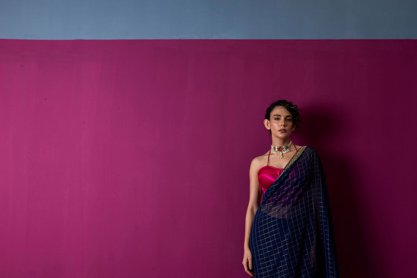 A Navy Gold Checkered Saree with Fuchsia Corset Blouse