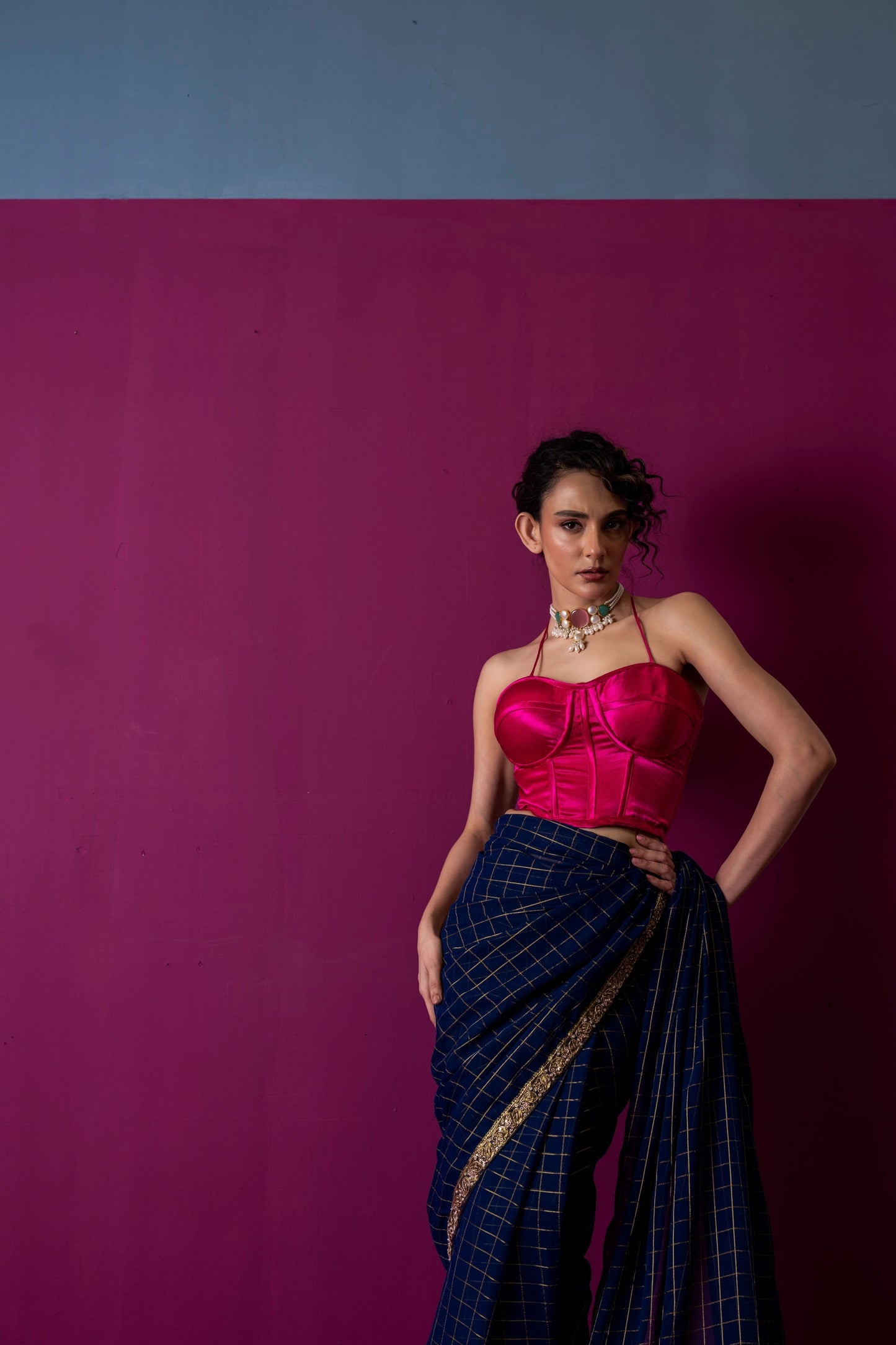 A Navy Gold Checkered Saree with Fuchsia Corset Blouse