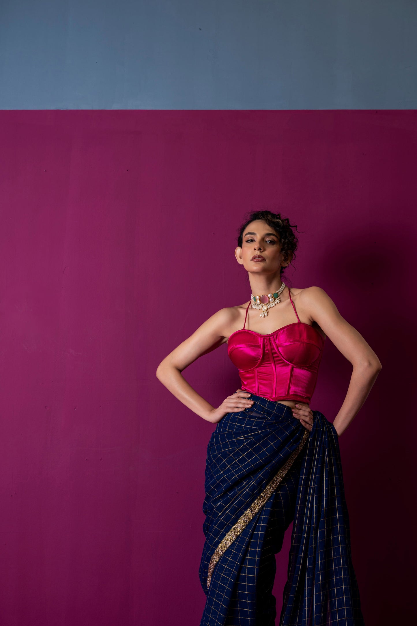 A Navy Gold Checkered Saree with Fuchsia Corset Blouse
