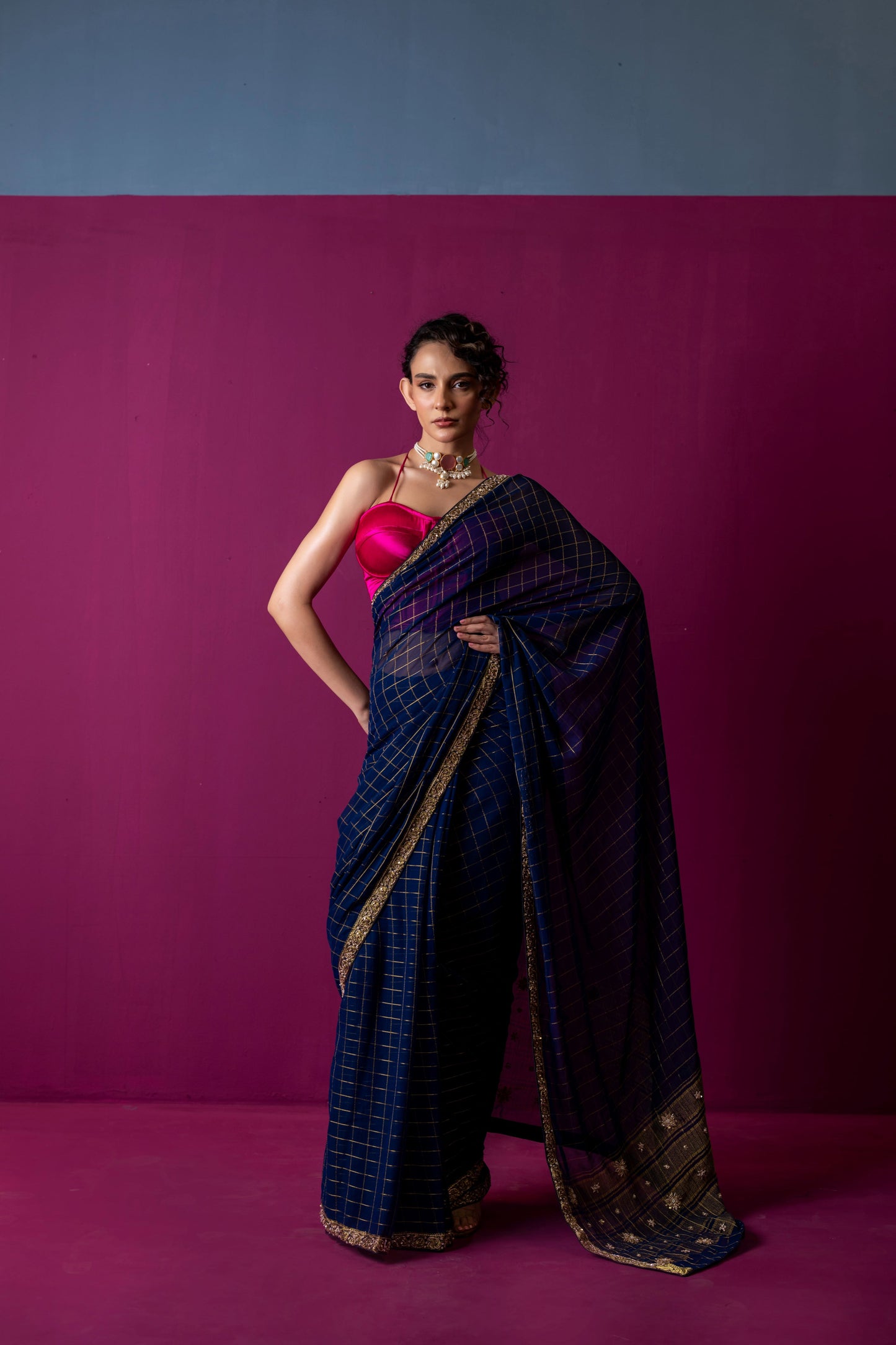 A Navy Gold Checkered Saree with Fuchsia Corset Blouse