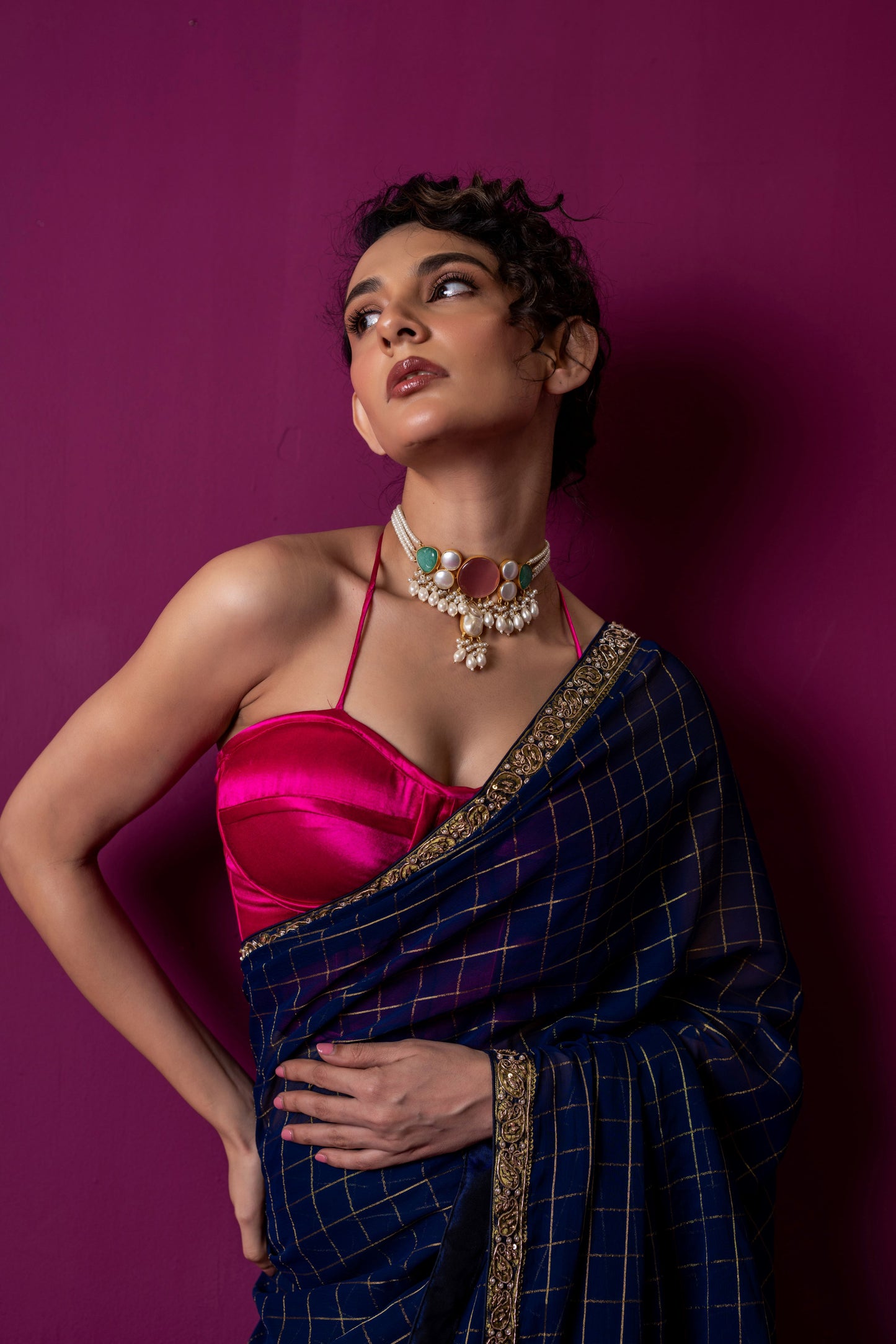 A Navy Gold Checkered Saree with Fuchsia Corset Blouse